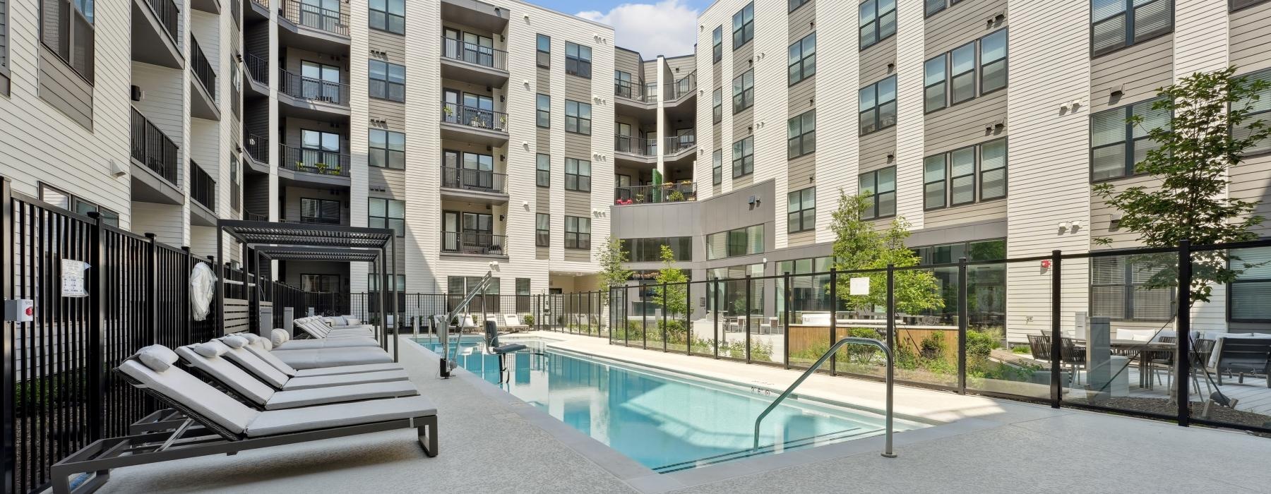 Resort-style swimming pool with lounge seating