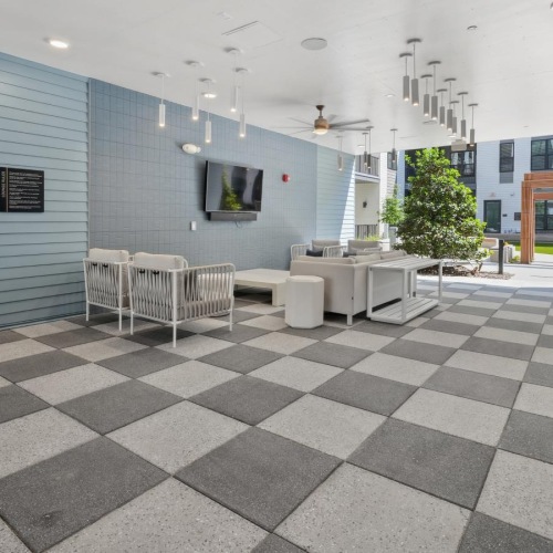 a spacious outdoor area with a media sitting area
