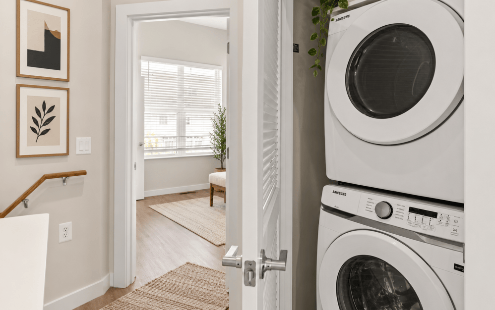 C4 floor plan at Alta NOVA featuring a stacked in-home washer and dryer, modern finishes, and a bright hallway with wood-style flooring.