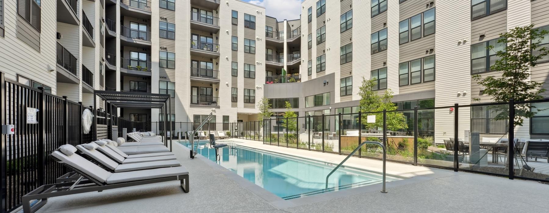 Resort-style swimming pool with lounge seating