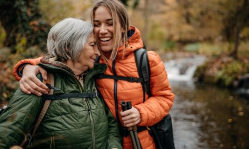 a couple of women smiling while hiking