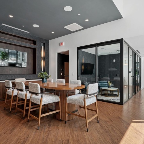 a room with a table chairs and a tv