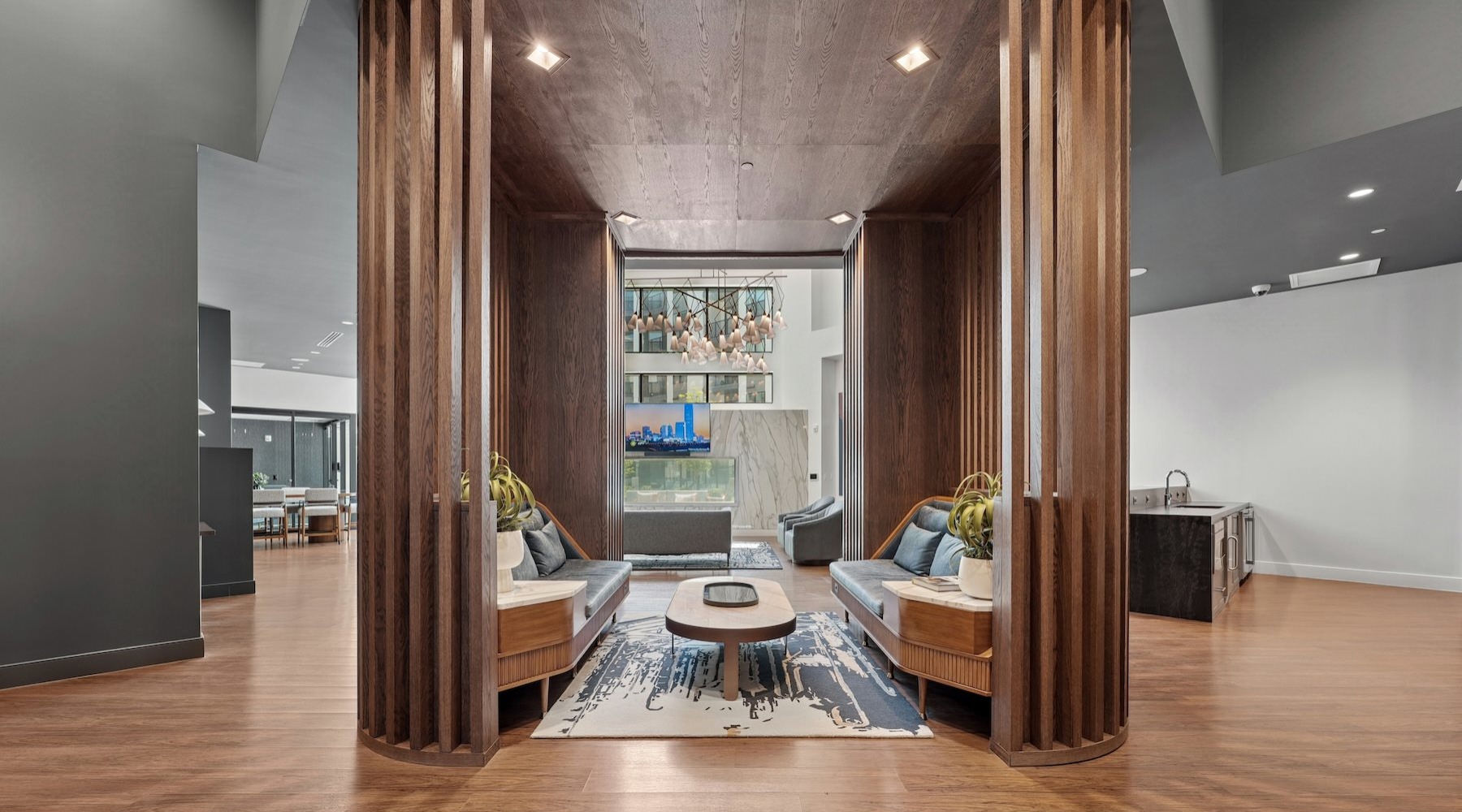 lounge with wood walls seating tables tv and large windows