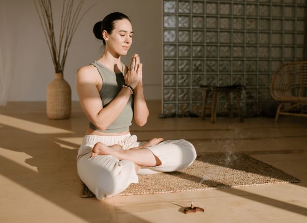 Alta Nova luxury apartment building woman practicing meditation