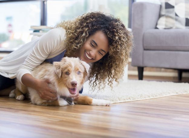 Alta Nova Luxury apartment building woman playing with puppy